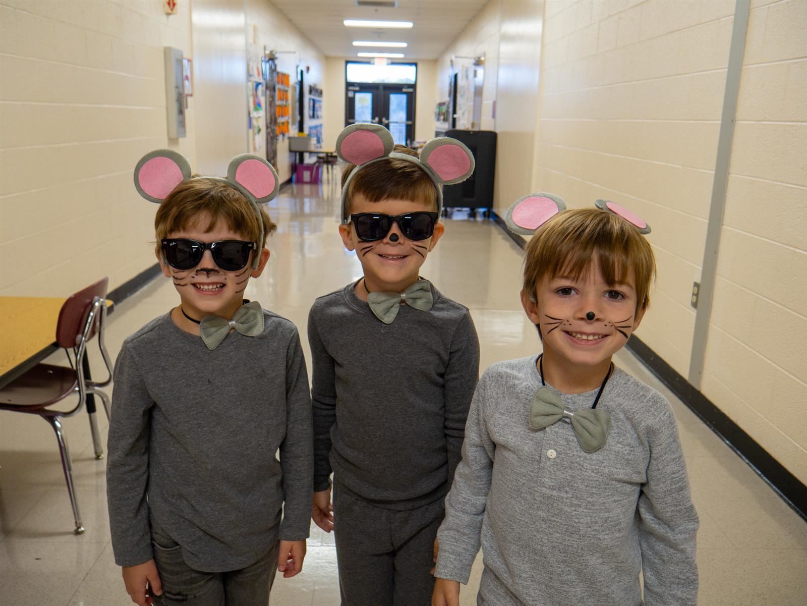 three boys in blind mice costumes